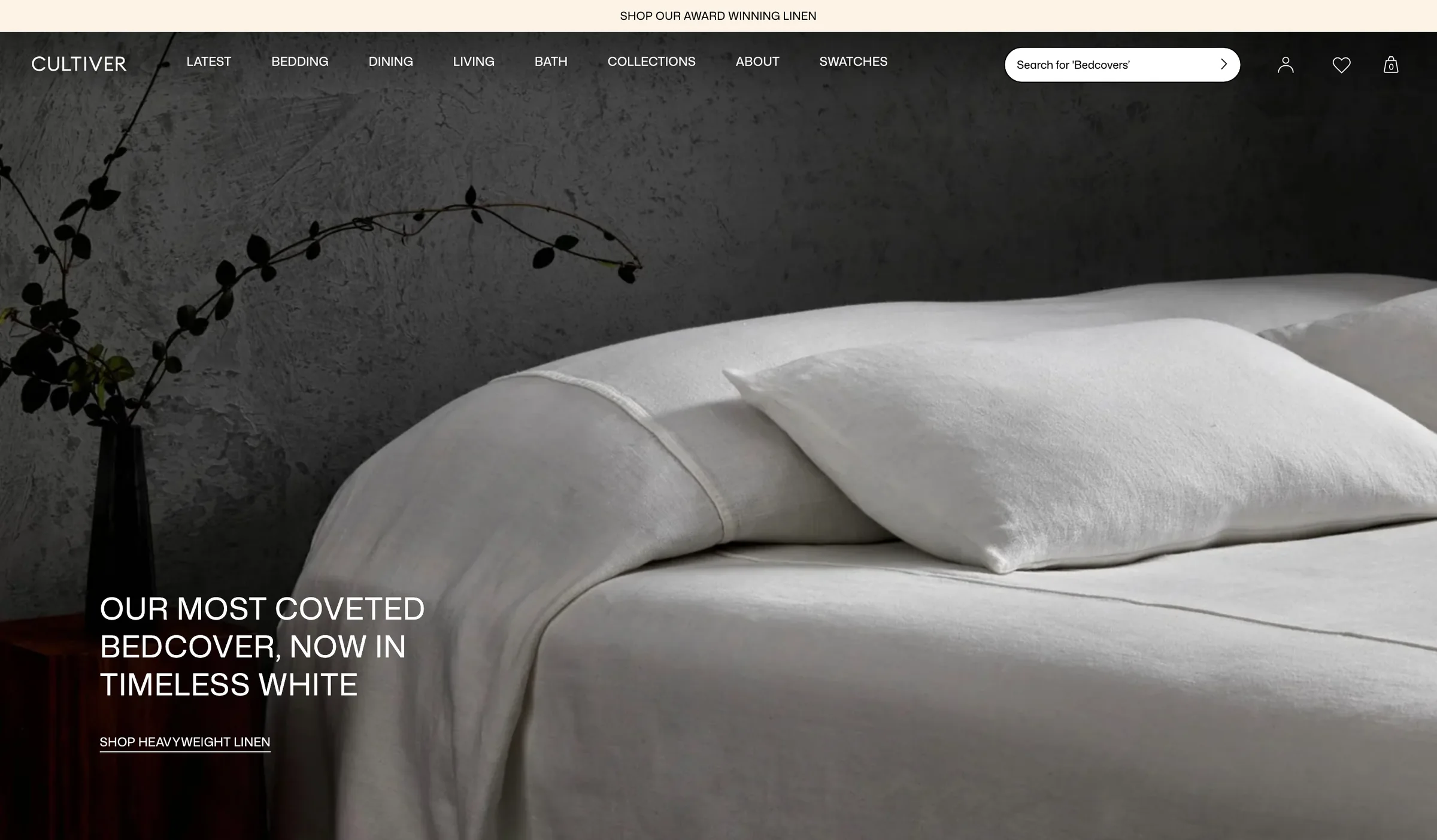 Cultiver homepage on desktop: a white heavyweight linen bedcover against a dark plaster wall, under the headline 'Our most coveted bedcover, now in timeless white'